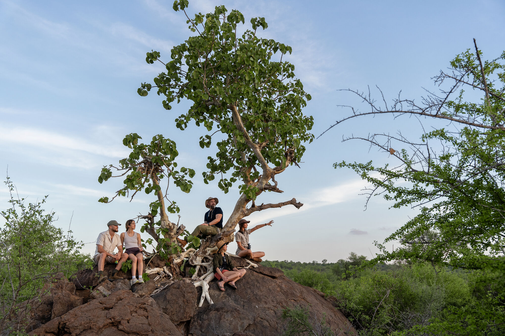 Guests taking in the African wilderness from a rocky outcrop