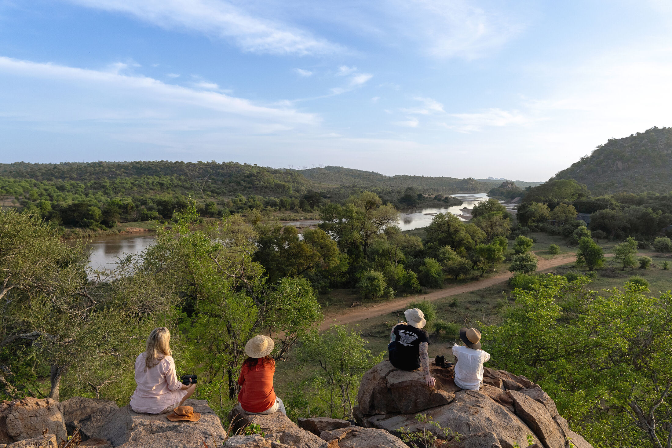 Guests taking in the river view in the African wilderness